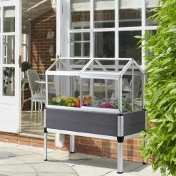 Mini Serre Sur Pieds Dim. 113L X 61l X 128H Cm - 4 Lucarnes, 2 Portes Coulissantes - Piètement Structure Alu. PVC Aspect Bois Gris Polycarbonate